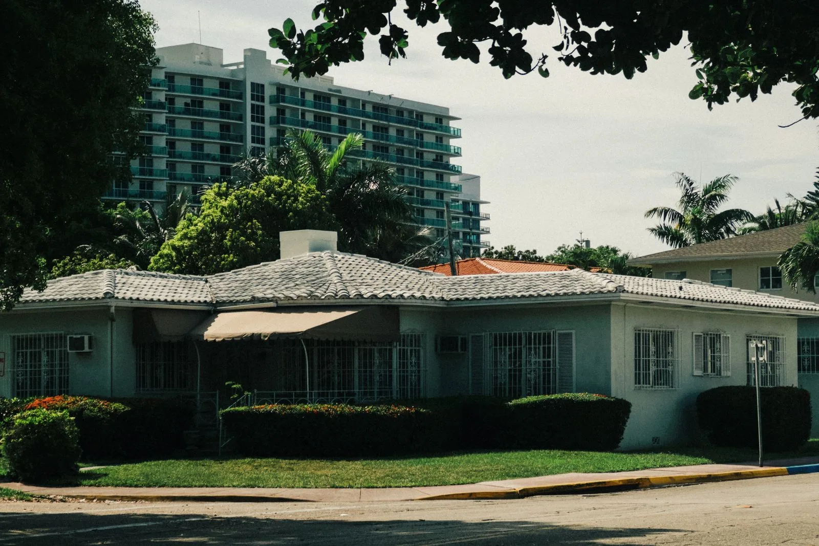 Single-story Miami home with a high-rise behind it