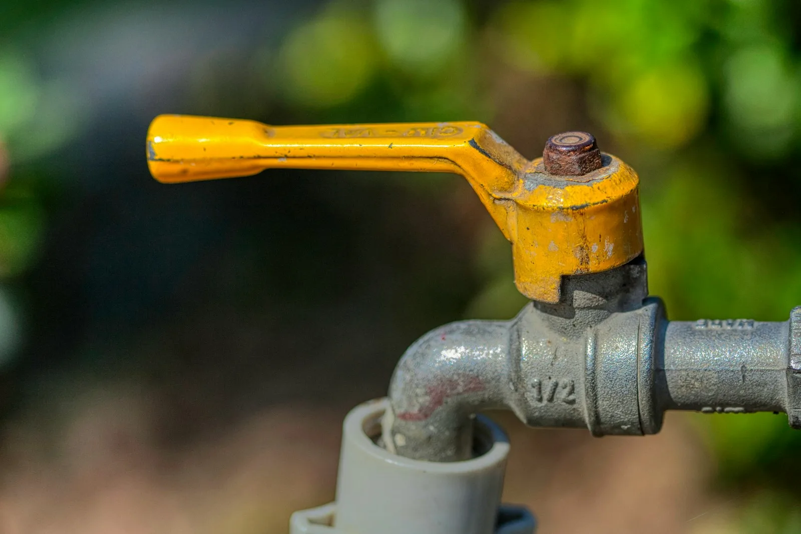 Lever-handle water shutoff valve on an outdoor pipe